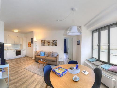 a living room with a table and a couch at Ohlerich Speicher App_ 14 in Wismar