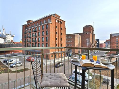 a balcony with a table and a view of a city at Ohlerich Speicher App_ 08 in Wismar