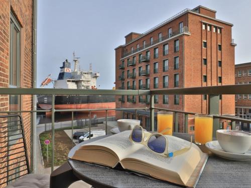 an open book on a table on a balcony at Ohlerich Speicher App_ 08 in Wismar