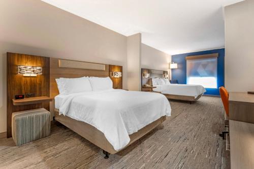 a hotel room with a large bed and a desk at Holiday Inn Express Breezewood by IHG in Breezewood