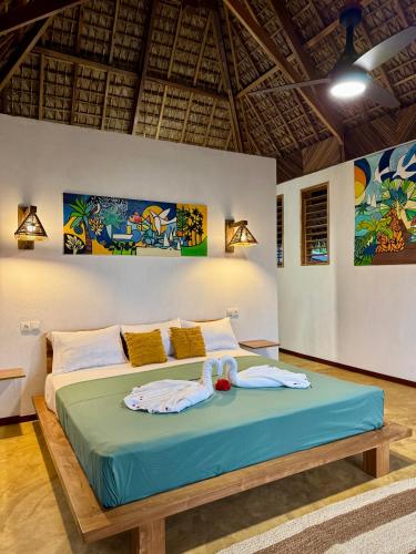 a bedroom with a bed in a room at Mahé Lodge, Nosy Be in Nosy Be