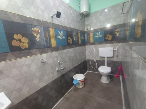 a bathroom with a white toilet in a room at SD Residency - Yercaud in Yercaud