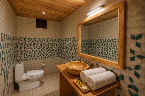 a bathroom with a toilet and a sink at Platinum Heritage Desert Camp in Jaisalmer