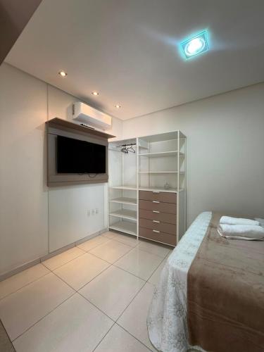 a bedroom with a bed and a flat screen tv at Casa grande e confortável! in Petrolina