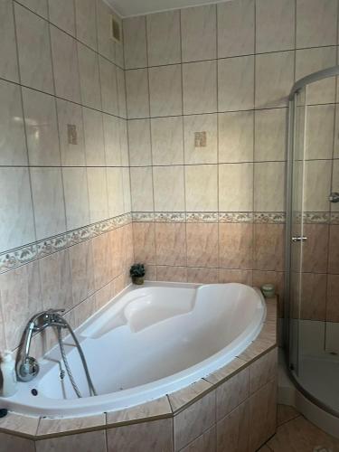 a bath tub in a bathroom with a shower at Sielski domek w Orawce in Jabłonka