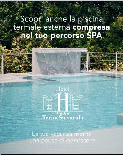 a sign for a fountain in a swimming pool at Hotel Terme Salvarola in Sassuolo