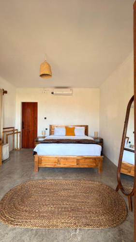 a bedroom with a large bed in a room at The Villa Indah Areguling in Kuta Lombok