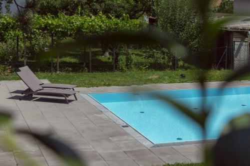 a chair sitting next to a swimming pool at Dream Getaway Apartment with Jacuzzi and Pool in Vienna