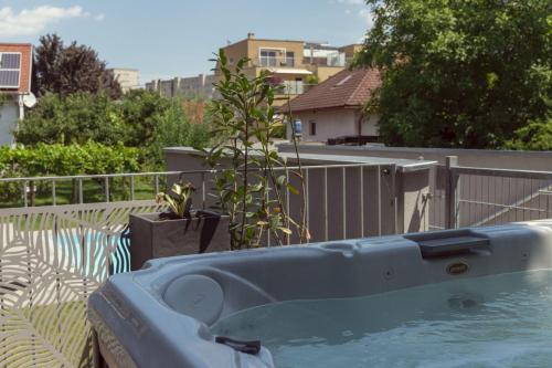 a blue bath tub in a yard with a plant at Dream Getaway Apartment with Jacuzzi and Pool in Vienna