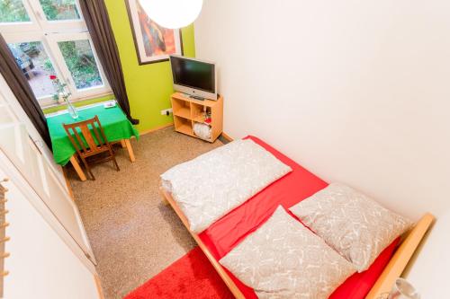 a small room with a bed and a television at finkeshaus in Lüdinghausen