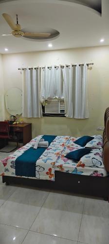 a bedroom with a bed and a window with curtains at The duggar villa in Jammu
