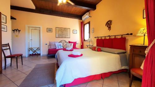 a bedroom with a large bed and a couch at Cappone B&B in Morciano di Romagna