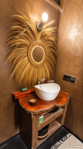 a bathroom with a white sink and a largeumedumedumedumedumed at BamBam Bungalows Zanzibar in Nungwi