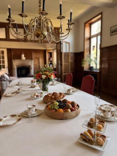 a long table with plates of food on it at Chateau entierement privatise in Hannut