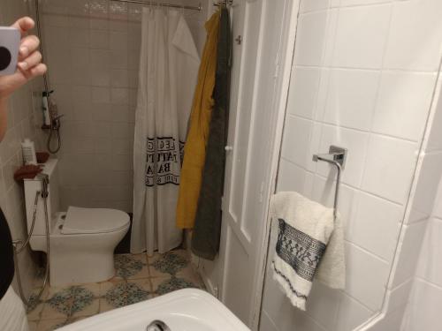 a person taking a picture of a bathroom with a toilet at Casa granada in Atarfe
