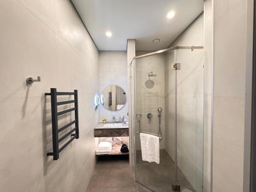 a bathroom with a shower and a sink at West Plaza Hotel in Oral
