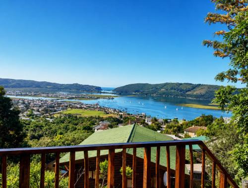 a view from the deck of a house overlooking a river at Knysna Lodge - Self Catering Accommodation with Woodfired Hot Tub in Knysna