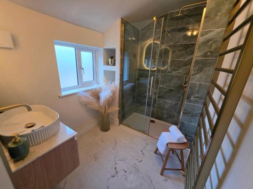 a bathroom with a shower and a sink at Fox House Llandudno in Llandudno