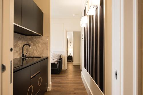 a kitchen with a sink and a counter top at Verona House Aparthotel in Verona