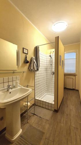 a bathroom with a white sink and a shower at Cappone B&B in Morciano di Romagna