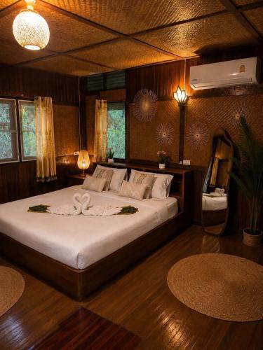 a bedroom with a large bed in a room at Thai house in Chaweng in Nathon Bay