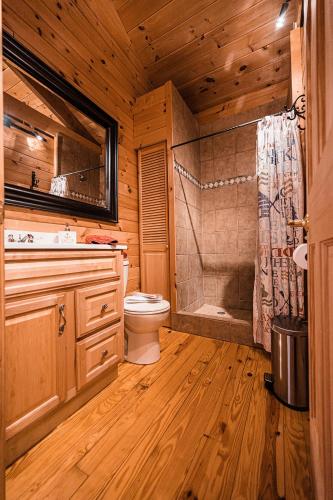 a wooden bathroom with a toilet and a shower at Sunset Chalet in Belgrade