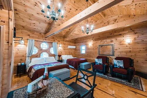 a bedroom in a log cabin with two beds and chairs at Sunset Chalet in Belgrade
