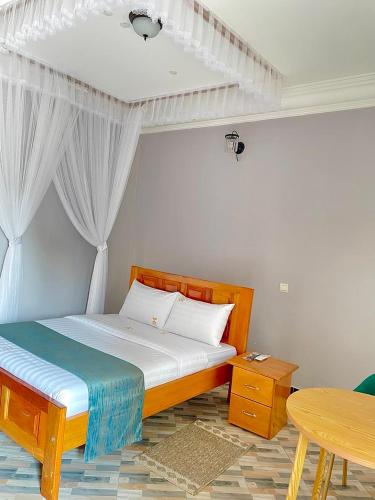 a bedroom with a bed and a table in it at Hotel Abiron in Wanseko
