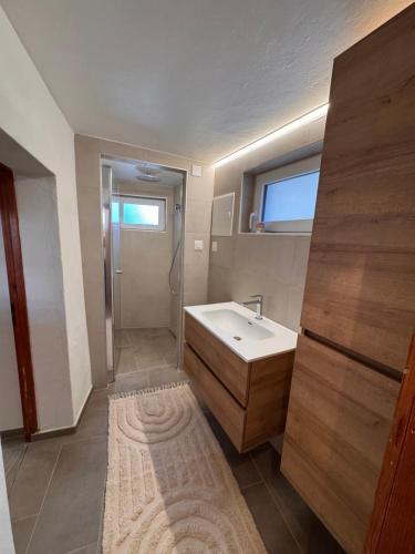 a bathroom with a white sink and a shower at Appartement Grande Dixence - Hérémence in Hérémence