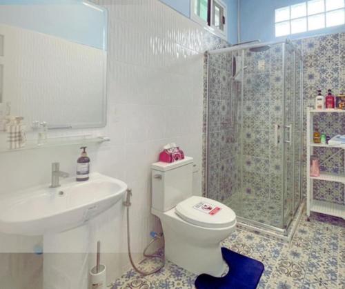 a bathroom with a sink and a toilet and a shower at Aura Home Kalasin in Kalasin