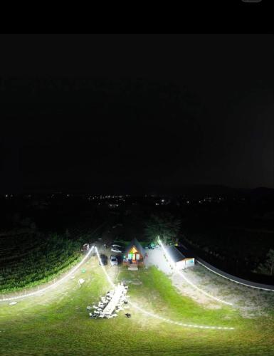 a park at night with a building and lights at Hillside Shilda in Shilda