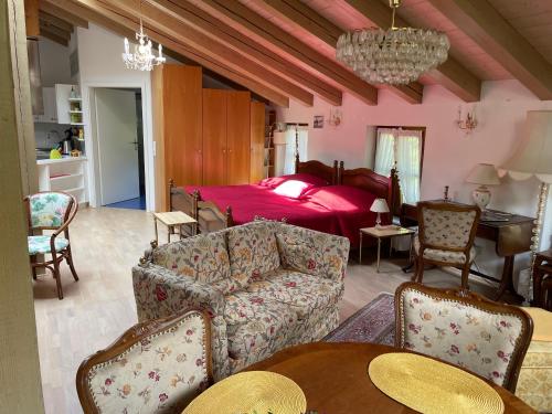 a living room with a couch and a bed at Landidyll Engelhofen in Obersontheim
