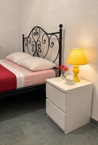 a bedroom with a bed with a lamp and a dresser at La Casetta Noble House in Casoli