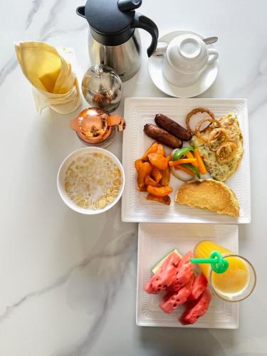 a table with three plates of breakfast food on it at Hotel Abiron in Wanseko