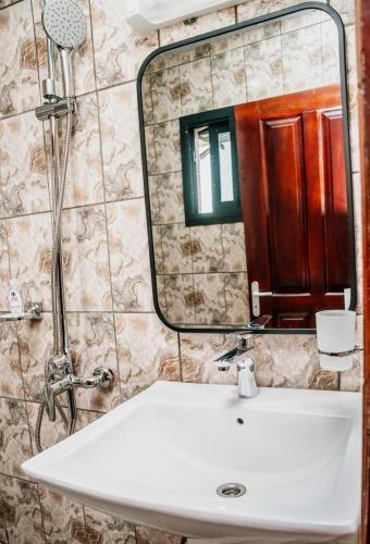 a bathroom with a sink and a mirror at Regal Hotel Douala in Douala