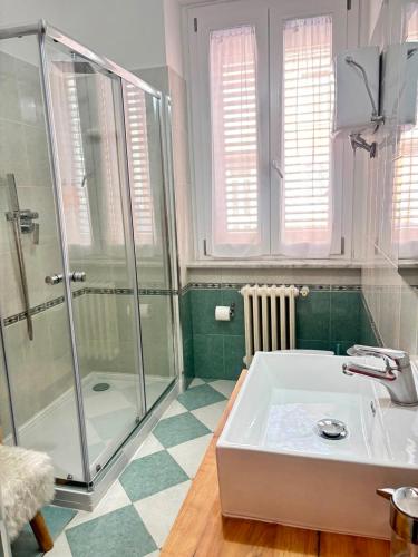 a bathroom with a shower and a white tub at Pasubio House appartamento in Campobasso