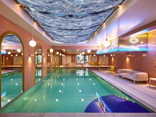 a pool in a hotel with a large swimming pool at Mama Shelter Rennes in Rennes