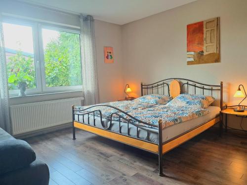 a bedroom with a bed and a window at Niederrheinhaus in Rheinberg