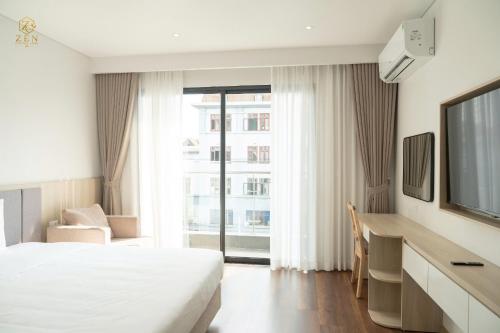 a hotel room with a bed and a large window at Zen Central Hotel Bac Giang in Bắc Giang