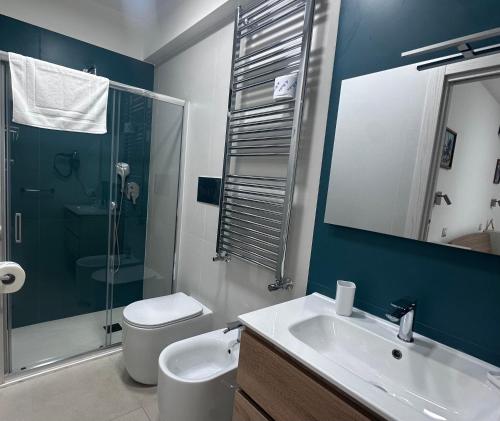 a bathroom with a toilet and a sink and a shower at B&B le Pontine in Gaeta