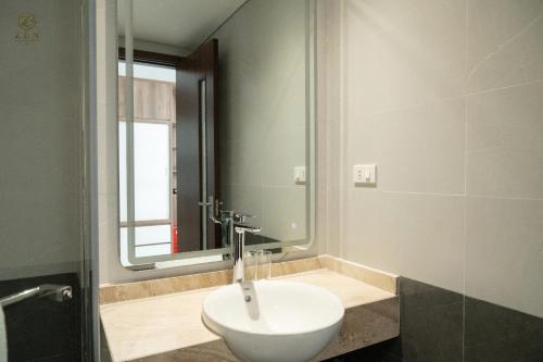 a bathroom with a sink and a mirror at Zen Central Hotel Bac Giang in Bắc Giang