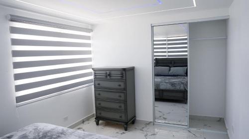 a dressing room with a mirror and a dresser at Bright & Comfortable 2BR San Juan Getaway in San Juan