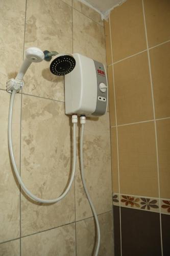 a shower in a bathroom with a blow dryer at Hakan Pension in Merdivenlikuyu