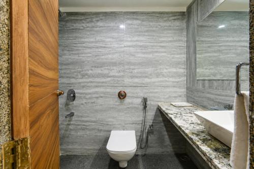 a bathroom with a toilet and a sink at Hotel Aradhana In Mount Abu in Mount Ābu