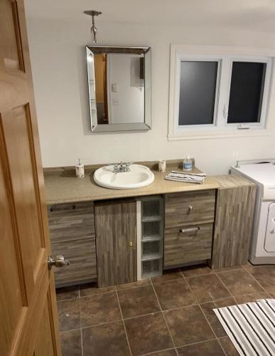 a bathroom with a sink and a mirror at Rustic Villa Country Getaway in Saint-Gabriel-de-Brandon