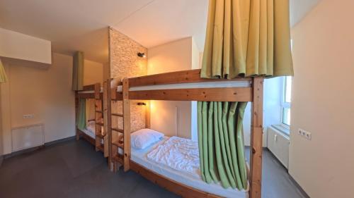 a couple of bunk beds in a room at Babelfish Hostel in Würzburg