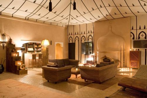 a living room with couches and a fireplace at Lodge K in Marrakech