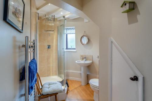 a bathroom with a shower toilet and a sink at 3 Bed in Kirkbymoorside oc-y100 in Kirkbymoorside