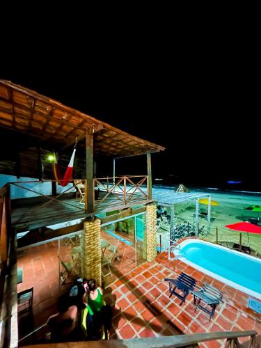 a view of a swimming pool at night at Pousada e restaurante casa dos ventos in Icapuí
