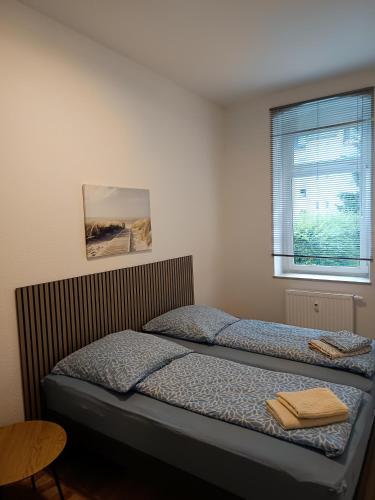 a bedroom with two beds and a window at Familie Lehmann in Gera
